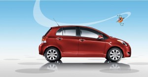 2009 Toyota Yaris 5-Door Liftback shown in Carmine Red Metallic with available 15-in. alloy wheels (photo courtesy of Toyota)